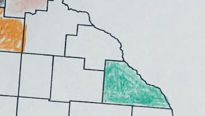 A printed out map zoomed in on southeast Minnesota. Winona County has been colored in with a green colored pencil. The some of the metro counties, on the edge of the image, have been colored as well