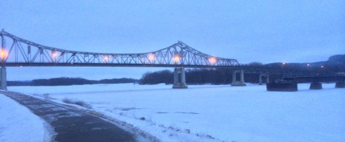 a bridge crosses the frozen Mississippi